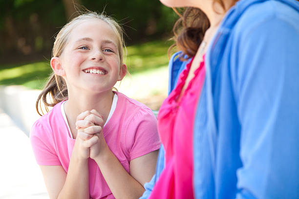 Young girl pleading with her mother for something Young girl pleading with her mother for something. pleading stock pictures, royalty-free photos & images