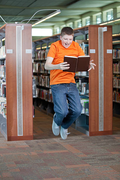istock Excited Teenager Jumping in Library 175410080
