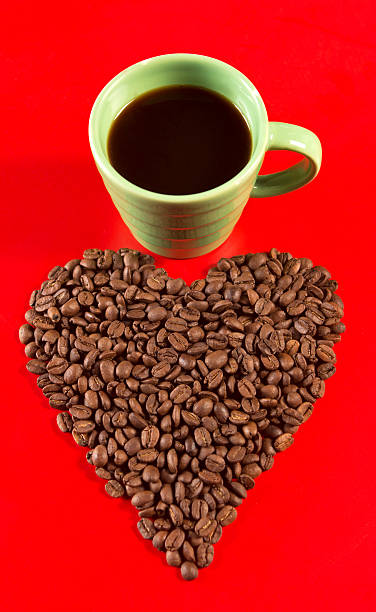 istock Heart shape made by coffee beans and mug 175410180