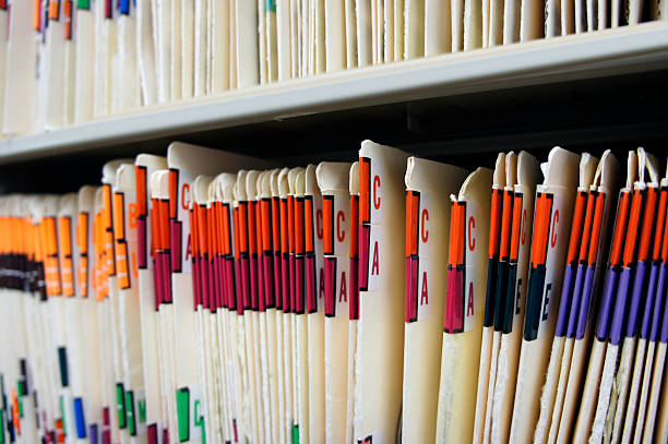 Various alphabetized medical records Medical records in file cabinet at doctor's office. medical record photos stock pictures, royalty-free photos & images