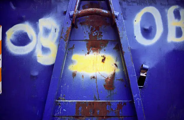 Photo of Industrial abstract with graffiti and rust - vivid colours