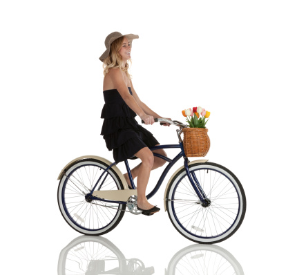 Profile of happy beautiful woman riding a bicycle