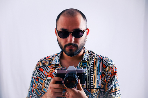 A model with glasses posing with the camera in the studio