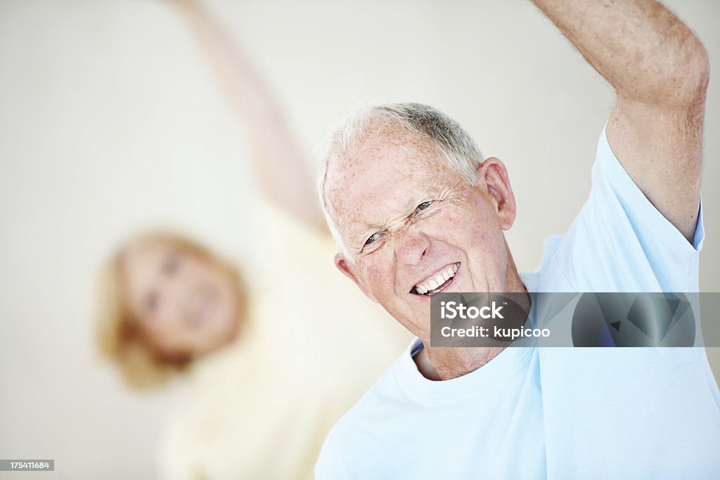 Anziani uomo e donna in Classe di yoga - Foto stock royalty-free di Abbigliamento sportivo