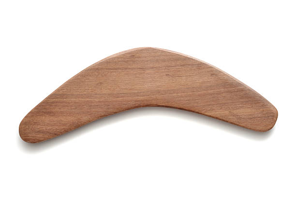 Boomerang Close up of a wood boomerang from Australia on a white background with shadows. boomerang stock pictures, royalty-free photos & images