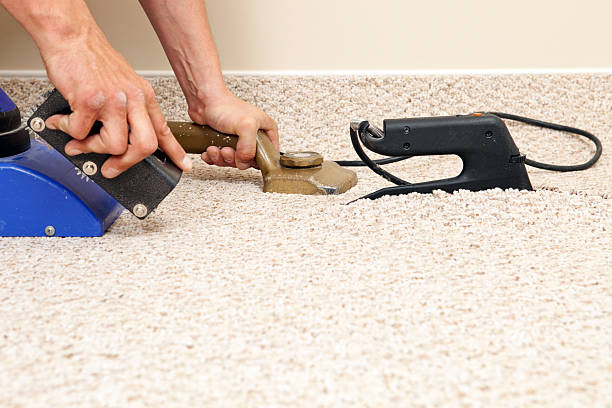 Installer Joining Two Carpet Pieces with Iron stock photo
