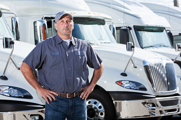 istock Truck driver standing in front of big rigs 175412164