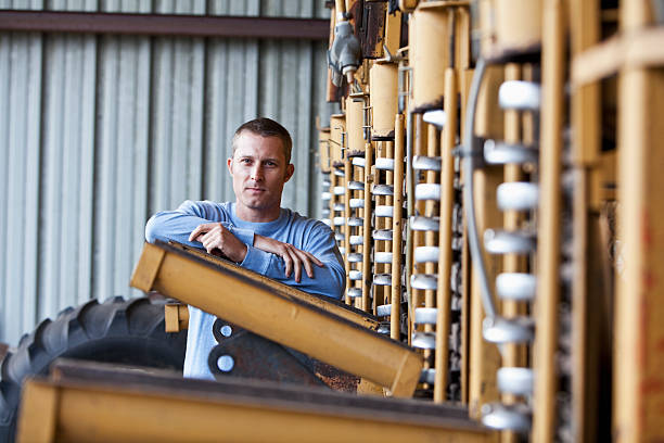 istock Farmer standing next to potato harvester 175412265