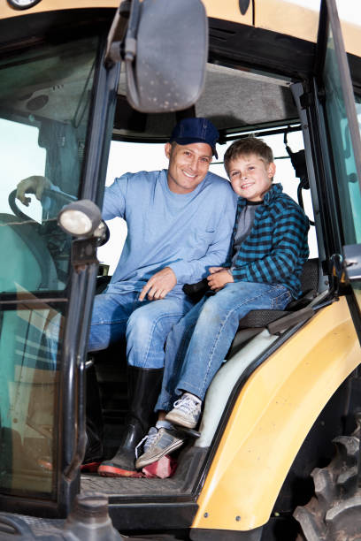 istock Boy and father on tractor 175412275