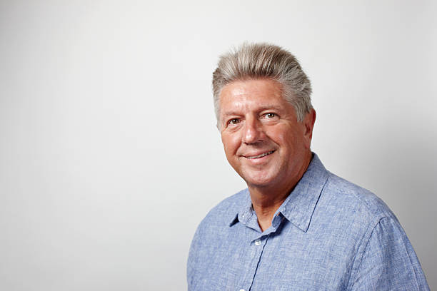 Mature man smiling head and shoulders portrait