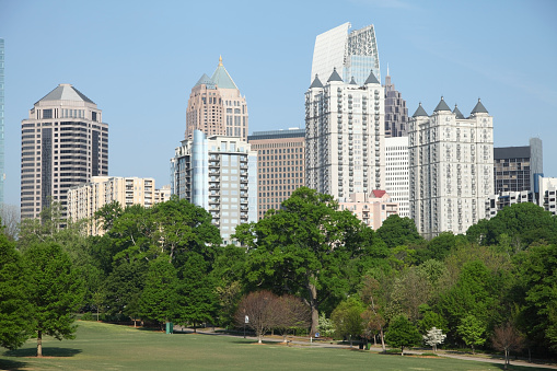 Atlanta downtown skyline from Piedmont Park. Piedmont Park is  urban park in Atlanta, Georgia, located about 1 mile northeast of Downtown. Atlanta is an economic and cultural hub of Georgia and known for its famous culinary talents, museums and outdoor attractions