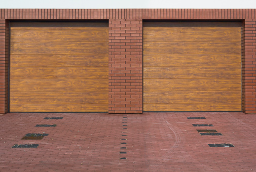 A brown double garage doors on a new home