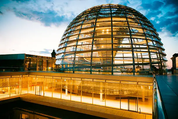 "Outside the illuminated Reichstag Dome at Twilight. Spiral walkways to the top of the Reichstag, Germany's parliament building in the heart of Berlin, Central Berlin, Germany."