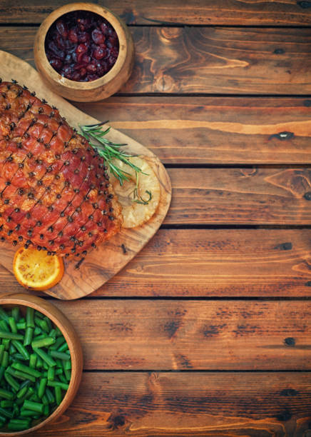 Traditional glazed holiday ham on the wooden background