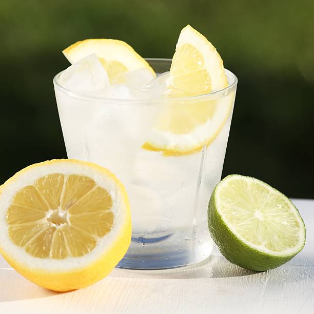 Summer drink Fresh drink with ice cubes, lemon, lime and mint. soda water glass lemon stock pictures, royalty-free photos & images