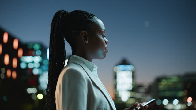 Night, thinking and business woman with phone on a rooftop for text, chat or communication. Working late, balcony and African entrepreneur with smartphone app for social media or taxi service search