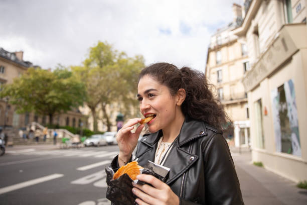 istock Turkish woman in Paris eating a pastry 1754139952