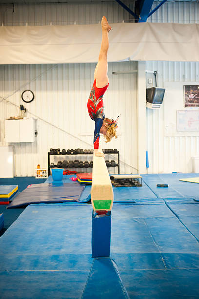 Level 5 Gymnast practicing on Beam stock photo