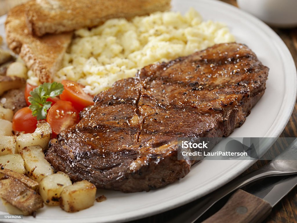 Steak and Eggs "Grilled Rib Eye Steak with Scrambled Eggs, Hash Browns, Fresh Tomatoes and Toast -Photographed on Hasselblad H3D2-39mb Camera" Steak Stock Photo