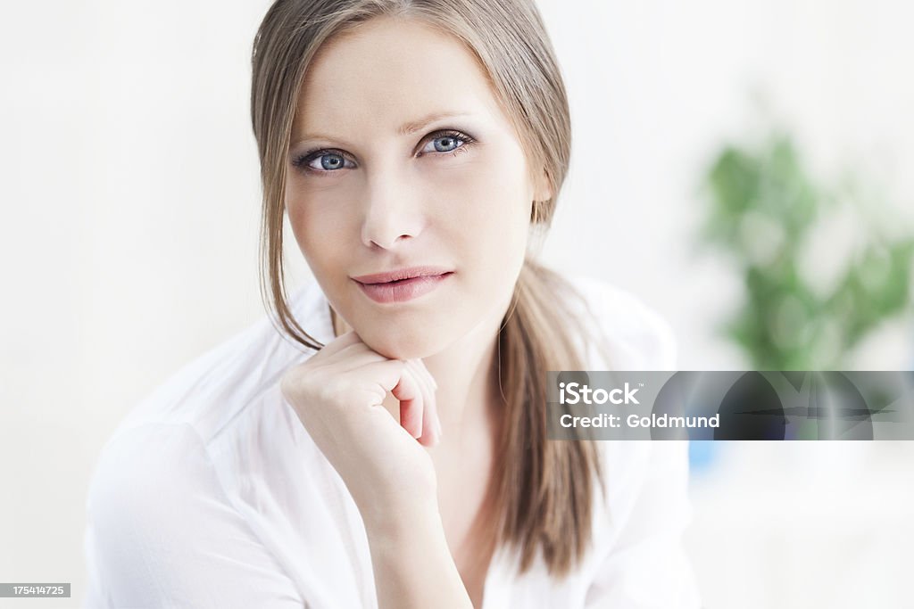 Portrait Of Young Woman "Close-up portrait of a beautiful, young woman looking at camera and holding hand on face." 20-24 Years Stock Photo