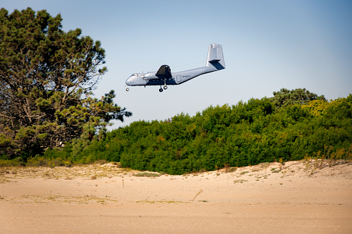 Coronado, California, USA - October 4, 2023: A Canadian Dehavilland Caribou DHC-4A arrives near the beach.