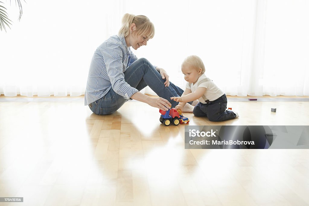 playing with toy truck Happy mother and her 1 year old son playing with toy truck at home.Please check my Playground \ Kids playing lightbox Baby - Human Age Stock Photo