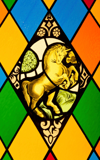 Stained glass window with diamond pattern and mythological animal