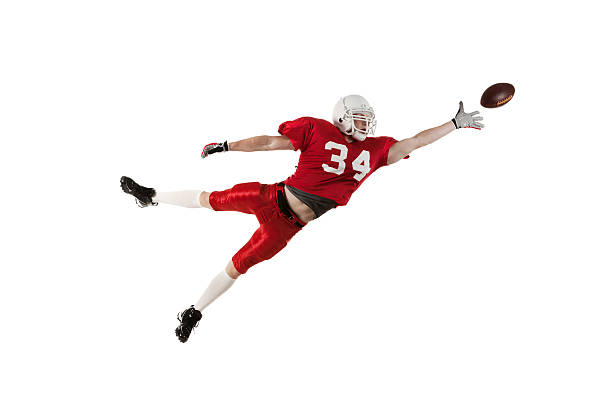 American football player in action American football player in action american football player studio stock pictures, royalty-free photos & images