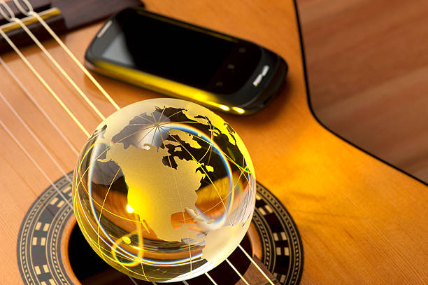 istock Acoustic guitar with globe and mobile phone 175415739