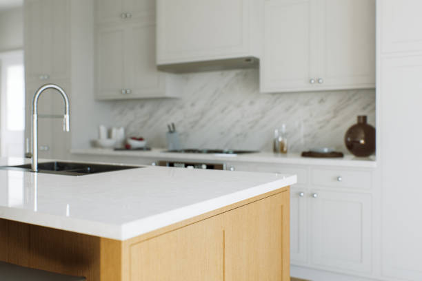 istock View of a kitchen island, white marble countertop with blurred white kitchen background for product presentation. Table with blurred kitchen background in bokeh. 3D rendering 1754157848