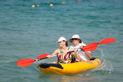 Adult couple doing kayaking at vacation.