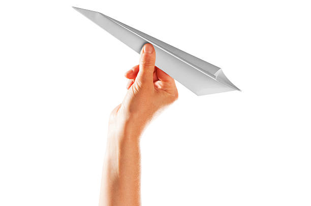 istock Hand holds paper airplane up into air against white background 175416194
