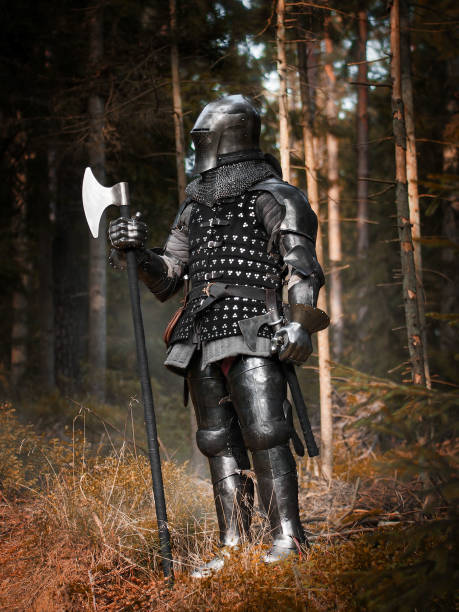 istock Medieval knight in forest holding an axe 1754161972