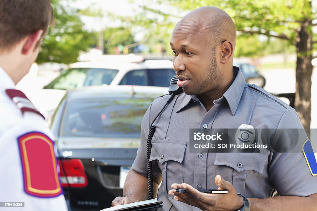 Policial interogating pessoas em uma cena de emergência - Foto de stock de Força Policial royalty-free