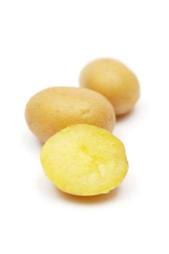 Prepared potatoes in a row. Isolated on a white background. Focus on foreground.