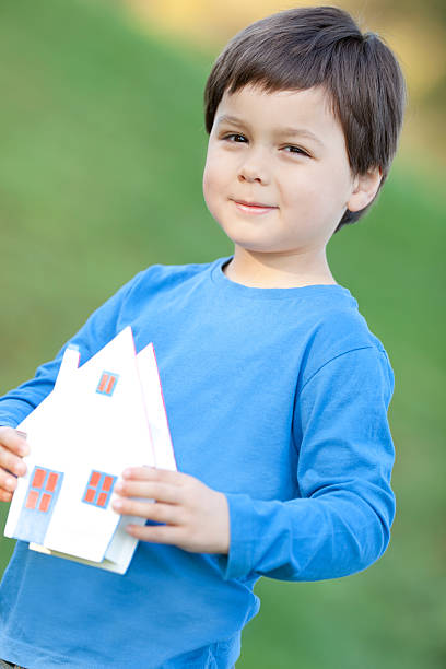 little boy with house miniature "little boy with house-miniature,for future family concepts,very selective focus on the boy (house selfmande)" hypothecary stock pictures, royalty-free photos & images