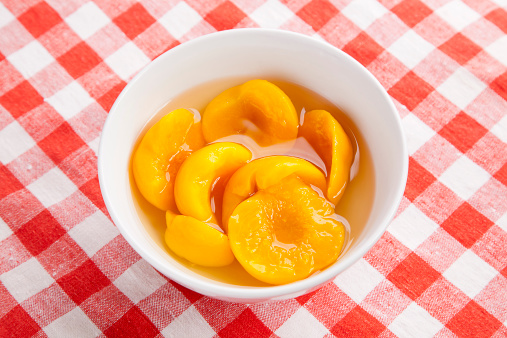 Canned Peaches in white bowl