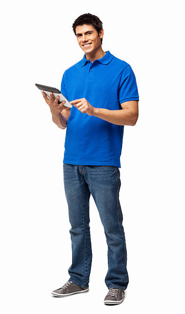 Happy young man using digital tablet on white background Full length portrait of a happy young man in casual wear using digital tablet. Vertical shot. Isolated on white. blue t shirt stock pictures, royalty-free photos & images