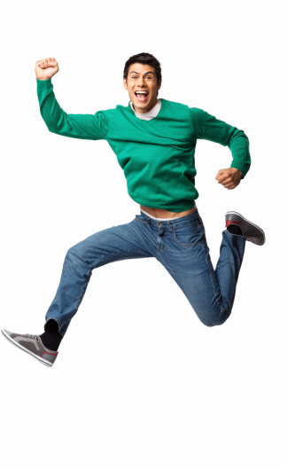 Full length portrait of an ecstatic young man cheering with clenched fists in mid-air. Vertical shot. Isolated on white.