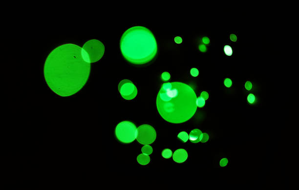 istock Green light, bokeh and glow on dark background isolated on a mockup space. Blur, black backdrop and defocused shine, sparkle or glitter at night for Christmas, holiday or party with magic color dots 1754177773