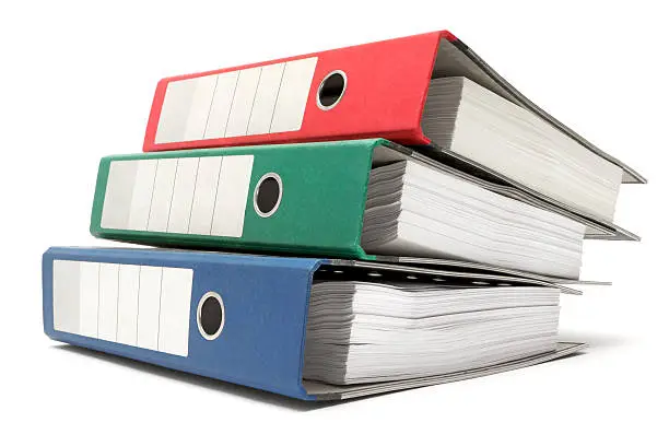 "Stacked red, green and blue ring binders. Isolated on a white background."