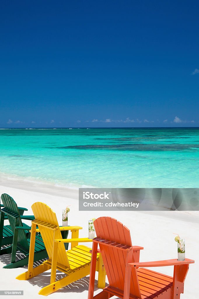 colorful chairs with drinks at a tropical Caribbean beach group of empty colorful chairs with mojito drinks at a tropical beach in the Caribbeanview images from the same series: British Virgin Islands Stock Photo