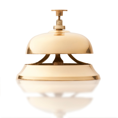 Brass hotel reception bell on a white background with clipping path