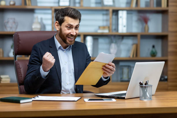 istock Happy successful boss received mail notification envelope with good news message, financier at workplace inside office, businessman happy with successful delivery results 1754192885