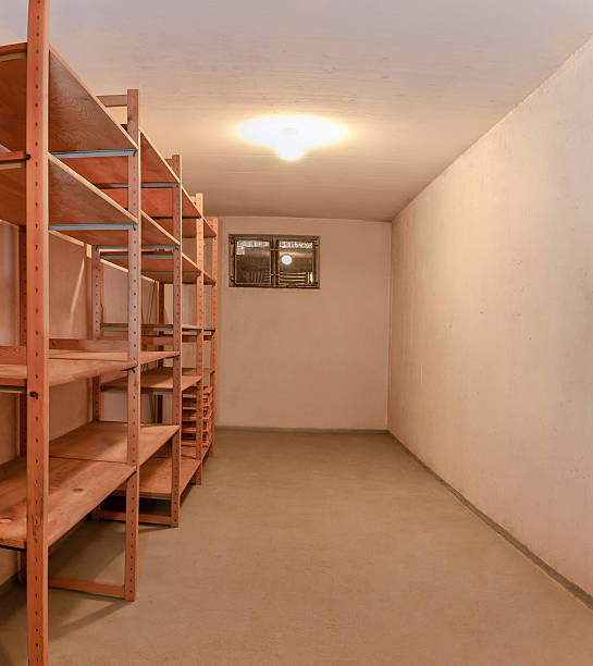Empty basement room wooden storage shelve illuminated ceiling lamp