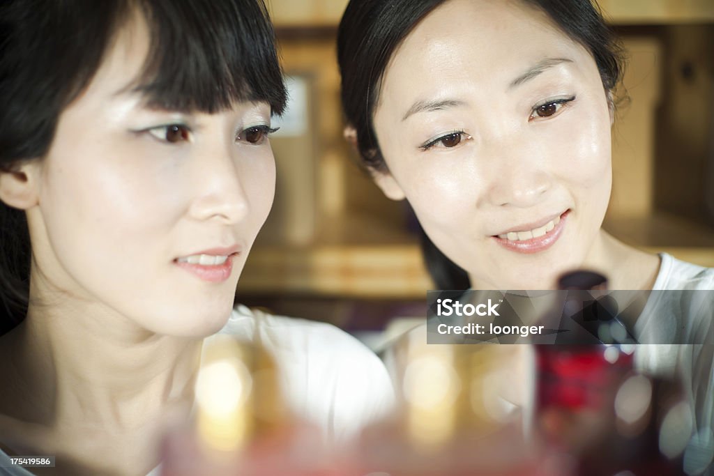 sisters enjoy buying cosmetics The east asian sisters enjoy buying cosmetics 20-29 Years Stock Photo