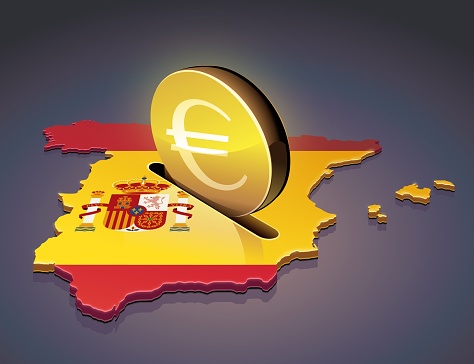 3D map of Spain in the colors of the spanish flag in which a gold coin with the euro symbol on a dark background