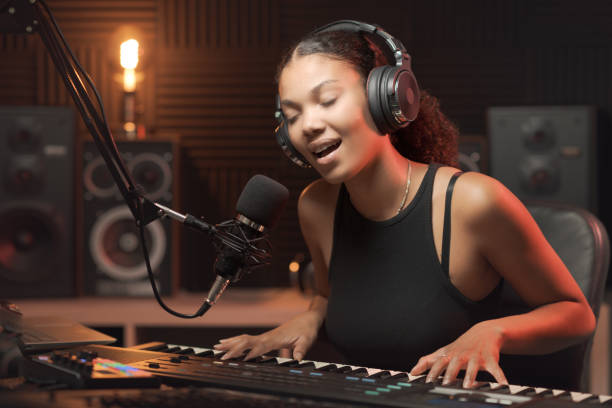 istock Woman singing and playing in the recording studio 1754199905