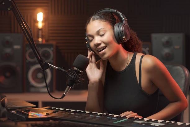 istock Woman singing and playing in the recording studio 1754201650