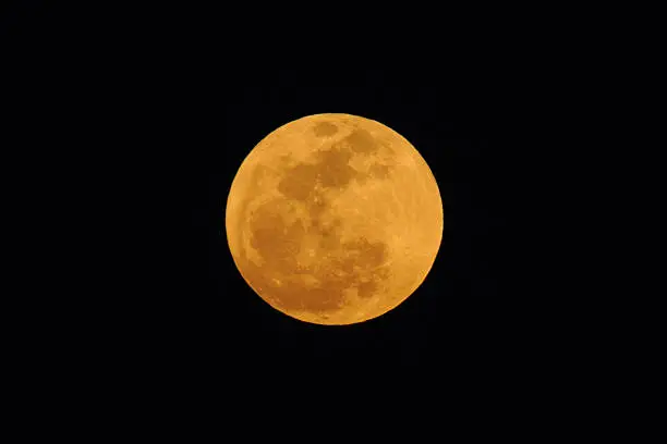 "This full moon photo was taken on May 5, 2012. When the full moon occurs at perigee it is called a supermoon since the appears a bit larger then other full moons because it is at the closest disatance to the earth on it's elliptical orbit. The orange color is caused by light scattering in the Earth's atmosphere."